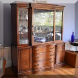 F32. Mahogany china cabinet with serpentine drawers. 70”h x 44”w x 16”d - $275 